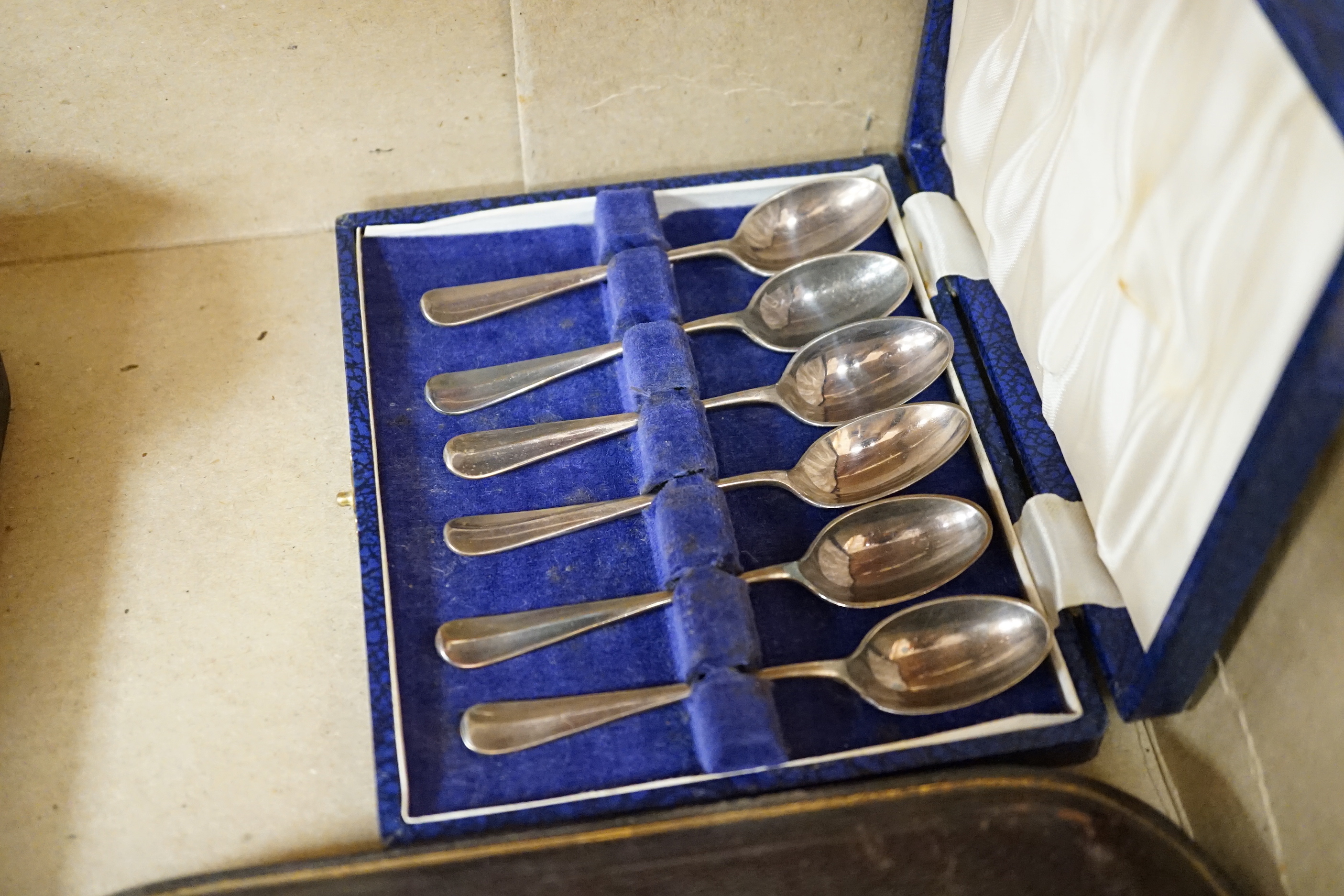 A group of assorted cased flatware comprising a set of six silver coffee spoons, Birmingham 1949, 100 grams, a silver fork and plated spoon christening set, fork 49 grams, a set of five Edwardian silver teaspoons and ton